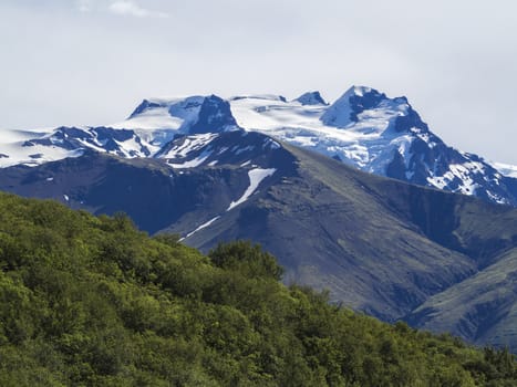 View on top of Hvannadalshnukur peak, highest iceland mountain and green bush, in Vatnajokull National Park