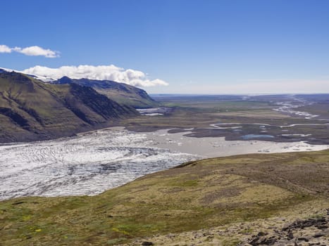 View on glacier lagoon with icebergs and tongue of Skaftafellsjokull, Vatnajokull spur, valley Morsardalur river and colorful rhyolit mountains in Skaftafell national park, Iceland