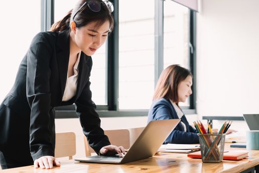 Asian businesswoman working with laptop for business analyze at meeting room.