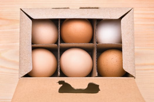 Egg box full. Cardboard box with brown eggs. Extra eggs background. Exclusive agricultural method. Organic egg in box. Packing egg. Chicken egg in carton box with hen cut out
