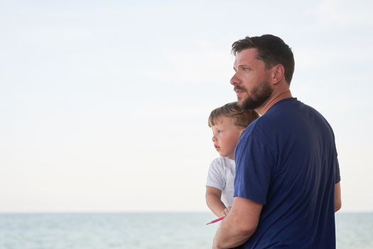 Father son spending time together sea vacation Young dad child little boy walking beach Fathers day. Family with one child. Happy childhood with daddy.