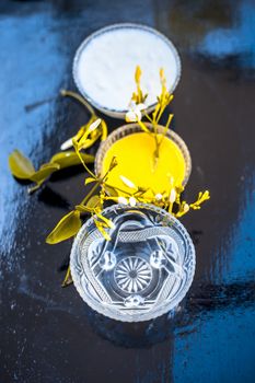 Ayurevidic face pack of Indian jasmine in a glass bowl on wooden surface i.e. jasmine Petals well mixed with milk cream & water. Used for skin whitening purposes.