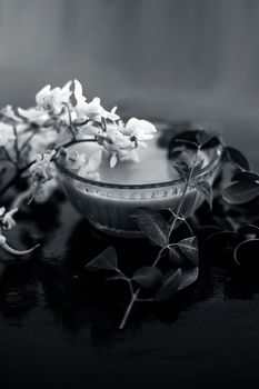 Ayurevidic Paste made from Moringa concanensis Nimmo also known as Kadvo Saragvo, Konkan Moringa in a glass bowl on wooden surface.