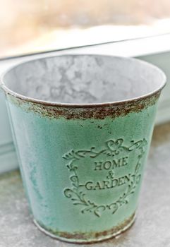 A turquoise Decoration Bucket with Home & Garden inscription