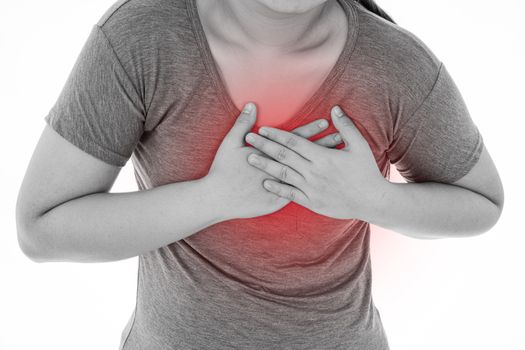 Black and white shot of woman feeling exhausted and suffering from heart pain and injury on isolated white background with red spot. Health care and medical concept.