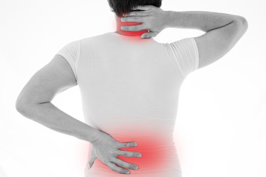 Black and white shot of man feeling exhausted and suffering from neck and back pain and injury on isolated white background with red spot. Health care and medical concept.
