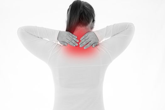 Black and white shot of woman feeling exhausted and suffering from shoulder and neck pain and injury on isolated white background with red spot. Health care and medical concept.