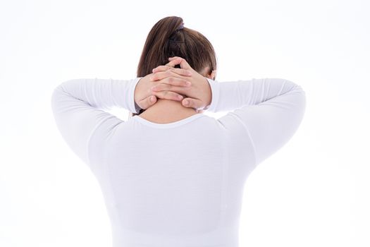 A woman feeling exhausted and suffering from shoulder and neck pain and injury on isolated white background. Health care and medical concept.