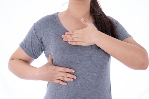 Healthcare, medicine and breast cancer awareness concept. Closeup on woman chest checking her breast on isolated white background, breast self exam.