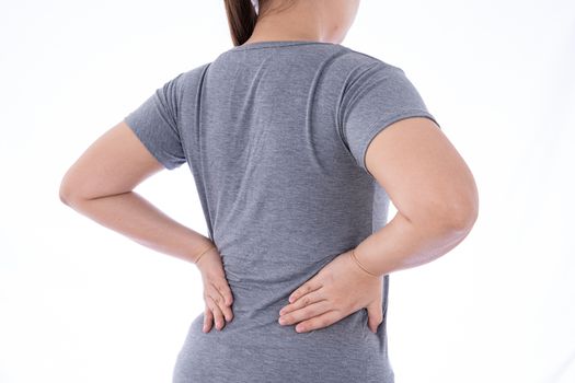 A woman feeling exhausted and suffering from waist and back pain and injury on isolated white background. Health care and medical concept.