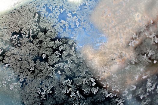 Beautiful texture with pattern of stars on slice of ice in the frost.