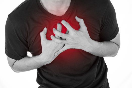Black and white shot of man feeling exhausted and suffering from heart pain and injury on isolated white background with red spot. Health care and medical concept.