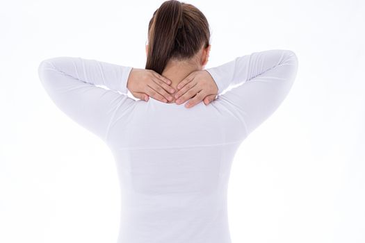 A woman feeling exhausted and suffering from shoulder and neck pain and injury on isolated white background. Health care and medical concept.
