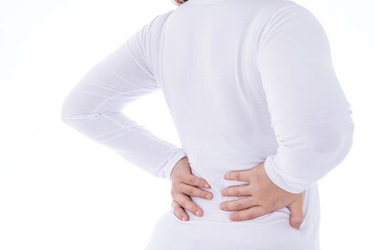 A woman feeling exhausted and suffering from waist and back pain and injury on isolated white background. Health care and medical concept.