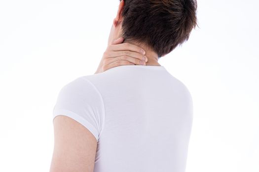 A man feeling exhausted and suffering from shoulder and neck pain and injury on isolated white background. Health care and medical concept.