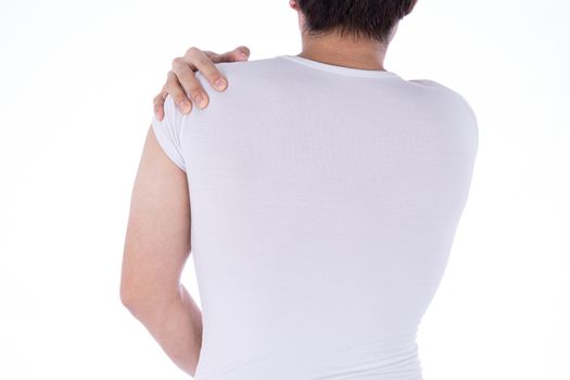 A man feeling exhausted and suffering from shoulder and neck pain and injury on isolated white background. Health care and medical concept.