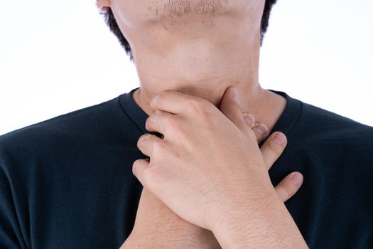 A man feeling exhausted and suffering from neck pain and injury on isolated white background. Health care and medical concept.