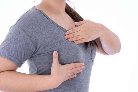 Healthcare, medicine and breast cancer awareness concept. Closeup on woman chest checking her breast on isolated white background, breast self exam.
