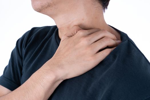 A man feeling exhausted and suffering from shoulder and neck pain and injury on isolated white background. Health care and medical concept.
