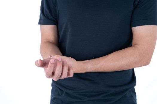 A man feeling exhausted and suffering from wrist pain and injury on isolated white background. Health care and medical concept.