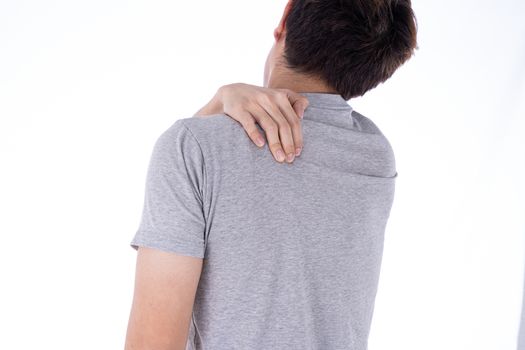 A man feeling exhausted and suffering from shoulder and neck pain and injury on isolated white background. Health care and medical concept.
