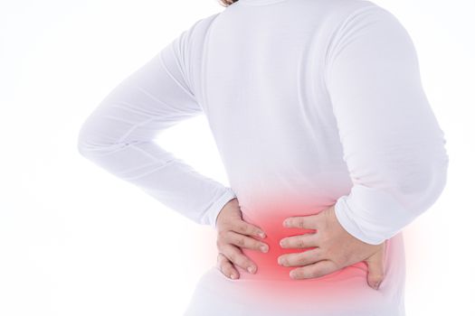 A woman feeling exhausted and suffering from waist and back pain and injury on isolated white background with red spot. Health care and medical concept.