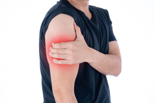A man feeling exhausted and suffering from arm pain and injury on isolated white background with red spot. Health care and medical concept.