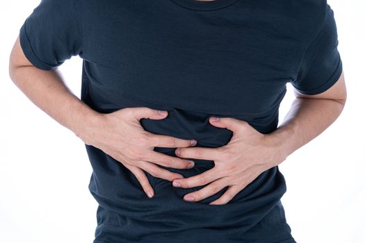 A man feeling exhausted and suffering from stomach pain and injury on isolated white background. Health care and medical concept.