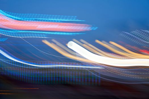 Amusement park blurred effect. Abstract illuminated background Spinning defocused carnival carousel long exposure shooting