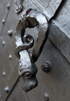 Old door knocker in a shape of a snake, Prague