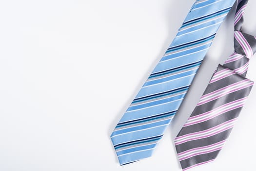 Happy Father Day background concept with blue and pink necktie on white background with copy space for text.