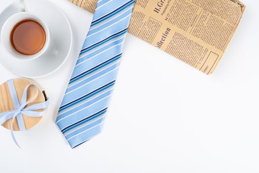 Happy Father Day background concept with blue necktie, cup of tea and gift box on white background with copy space for text.