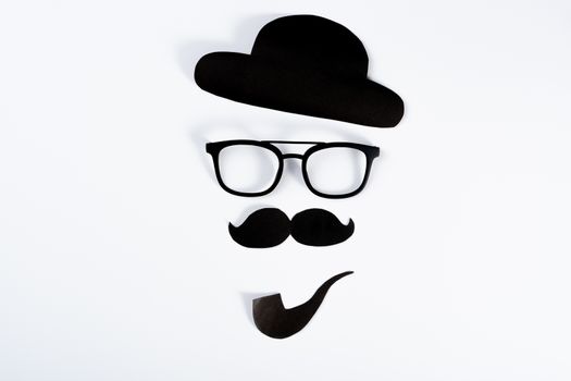 Happy Father Day background concept with paper cut of hat, glasses, black mustache and smoking pipe on white background with copy space for text.