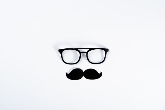 Happy Father Day background concept with glasses and black mustache on white background with copy space for text.