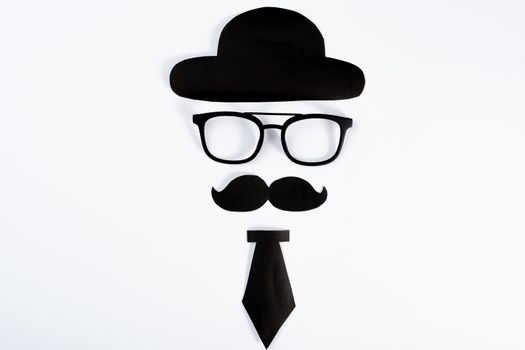 Happy Father Day background concept with paper cut of hat, glasses, black mustache and necktie on white background with copy space for text.