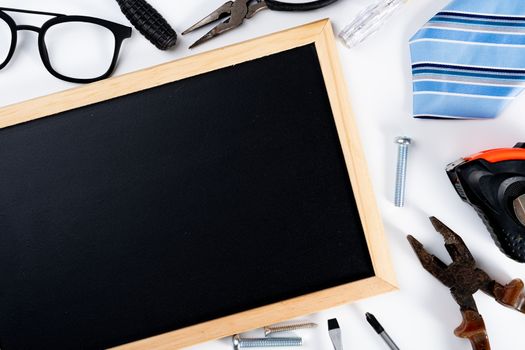 Happy Father Day background concept with tools, blackboard and tie on white background with copy space for text.