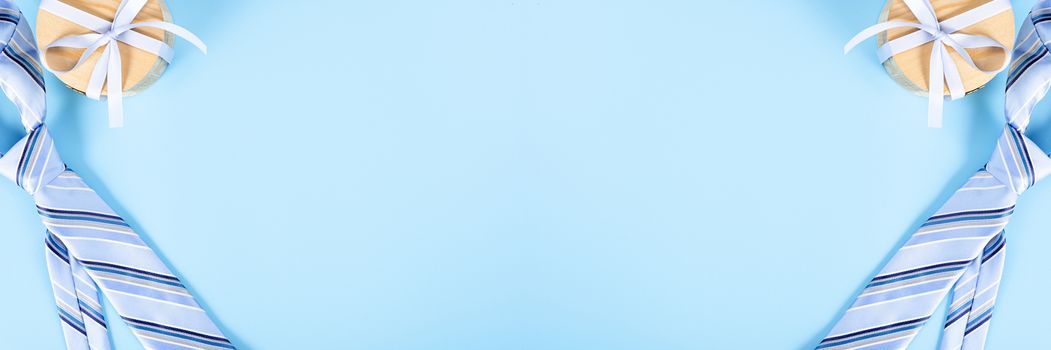 Happy Father Day background concept with blue necktie and gift box on blue background with copy space for text.