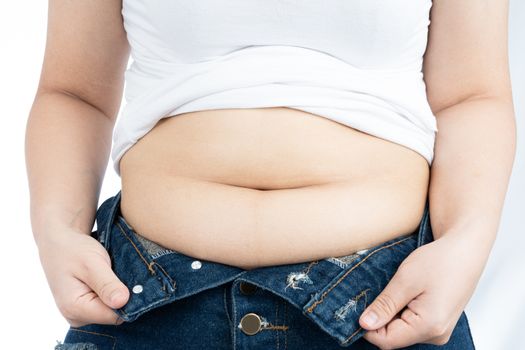 Fat woman holding excessive fat belly, overweight fatty belly isolated on over white background. Diet lifestyle, weight loss, stomach muscle, healthy concept.