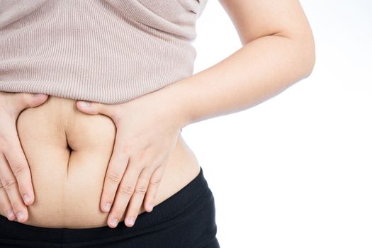 Fat woman holding excessive fat belly, overweight fatty belly isolated on over white background. Diet lifestyle, weight loss, stomach muscle, healthy concept.
