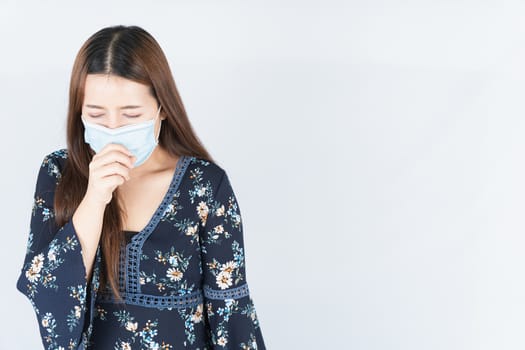 Asian beautiful happy hipster woman wearing a medical protection face mask for protect the coronavirus, filter dust PM 2.5 and cold and she coughing to mask on white background