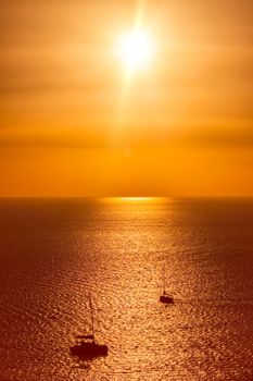 Yacht boats silhouettes in Aegean sea on sunset. Mykonos, Greece
