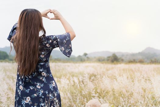 Summer portrait of young hipster woman standing in meadow on sunny day.young slim beautiful woman, bohemian outfit, indie style, summer vacation, sunny, having fun, positive mood, romantic, woman in hat