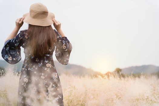 Summer portrait of young hipster woman standing in meadow on sunny day.young slim beautiful woman, bohemian outfit, indie style, summer vacation, sunny, having fun, positive mood, romantic, woman in hat