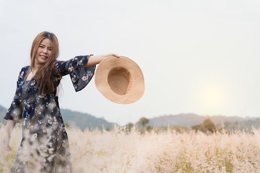Summer portrait of young hipster woman standing in meadow on sunny day.young slim beautiful woman, bohemian outfit, indie style, summer vacation, sunny, having fun, positive mood, romantic, woman in hat