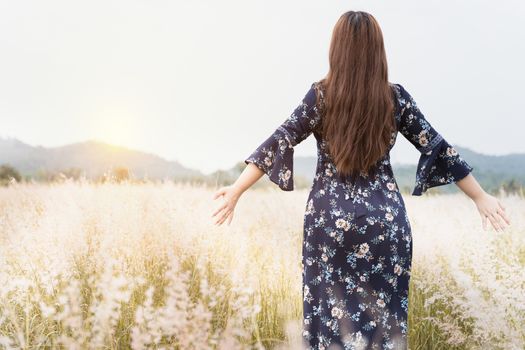 Summer portrait of young hipster woman standing in meadow on sunny day.young slim beautiful woman, bohemian outfit, indie style, summer vacation, sunny, having fun, positive mood, romantic, woman in hat