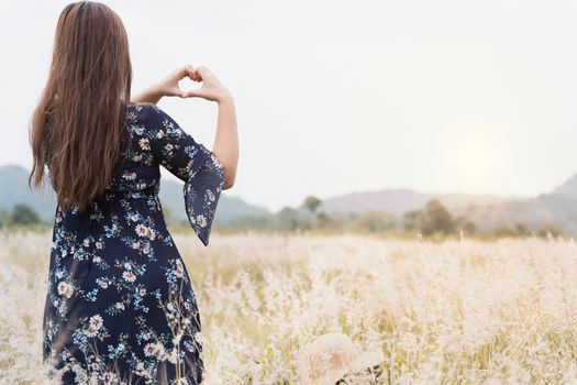 Summer portrait of young hipster woman standing in meadow on sunny day.young slim beautiful woman, bohemian outfit, indie style, summer vacation, sunny, having fun, positive mood, romantic, woman in hat