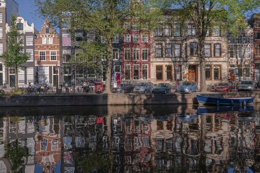 Amsterdam, the Netherlands -- July 30, 2019. 
A wide angle shot of houses taken across the Herengracht canal in Amsterdam.