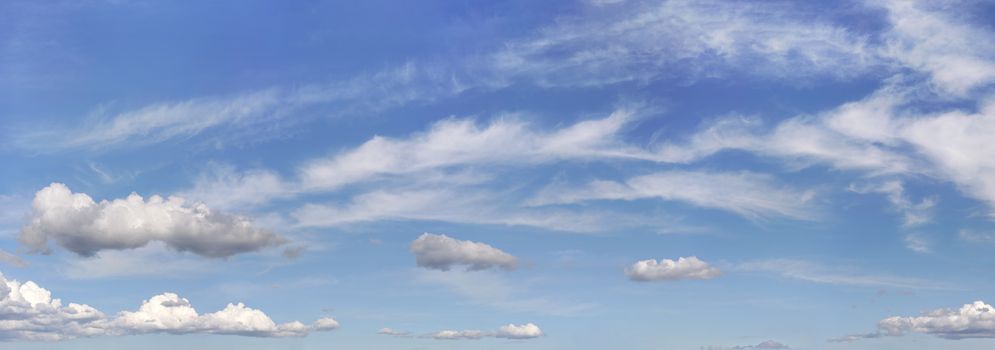 Bright sky background with few cirrus clouds above and small ones in lower part.