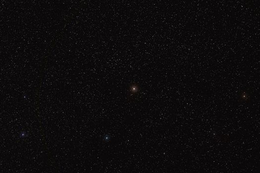 Many stars on night sky with bright Cebalrai meaning the shepherd's dog - Beta Ophiuchi of constellation Ophiuchus long stacked exposure photo .