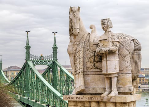 Budapest, HUNGARY - FEBRUARY 15, 2015 - Statue of Stephen I of Hungary on Gellert Hill, with a view of Liberty bridge and Danube river